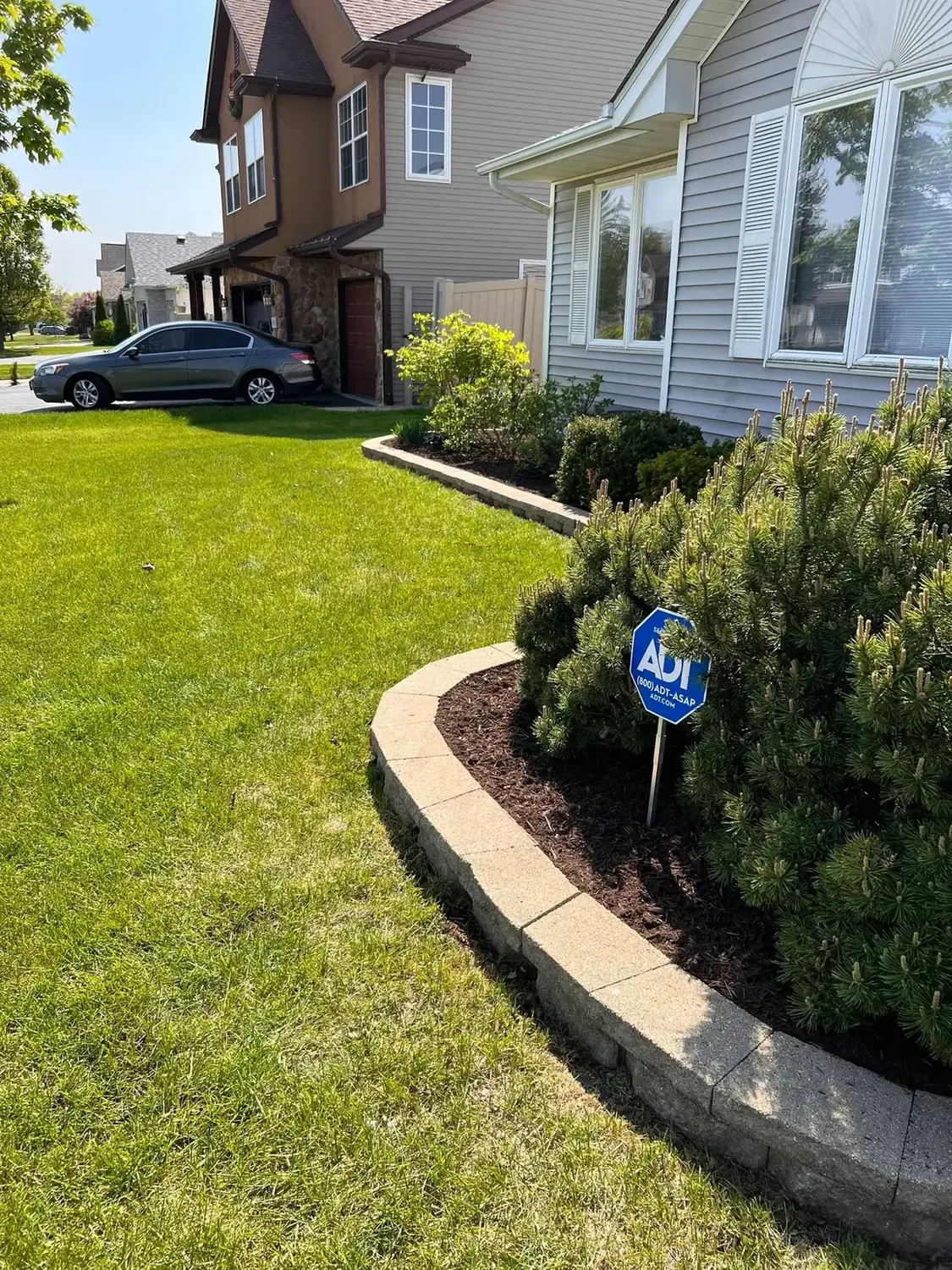 Curved stone landscape border beside a home