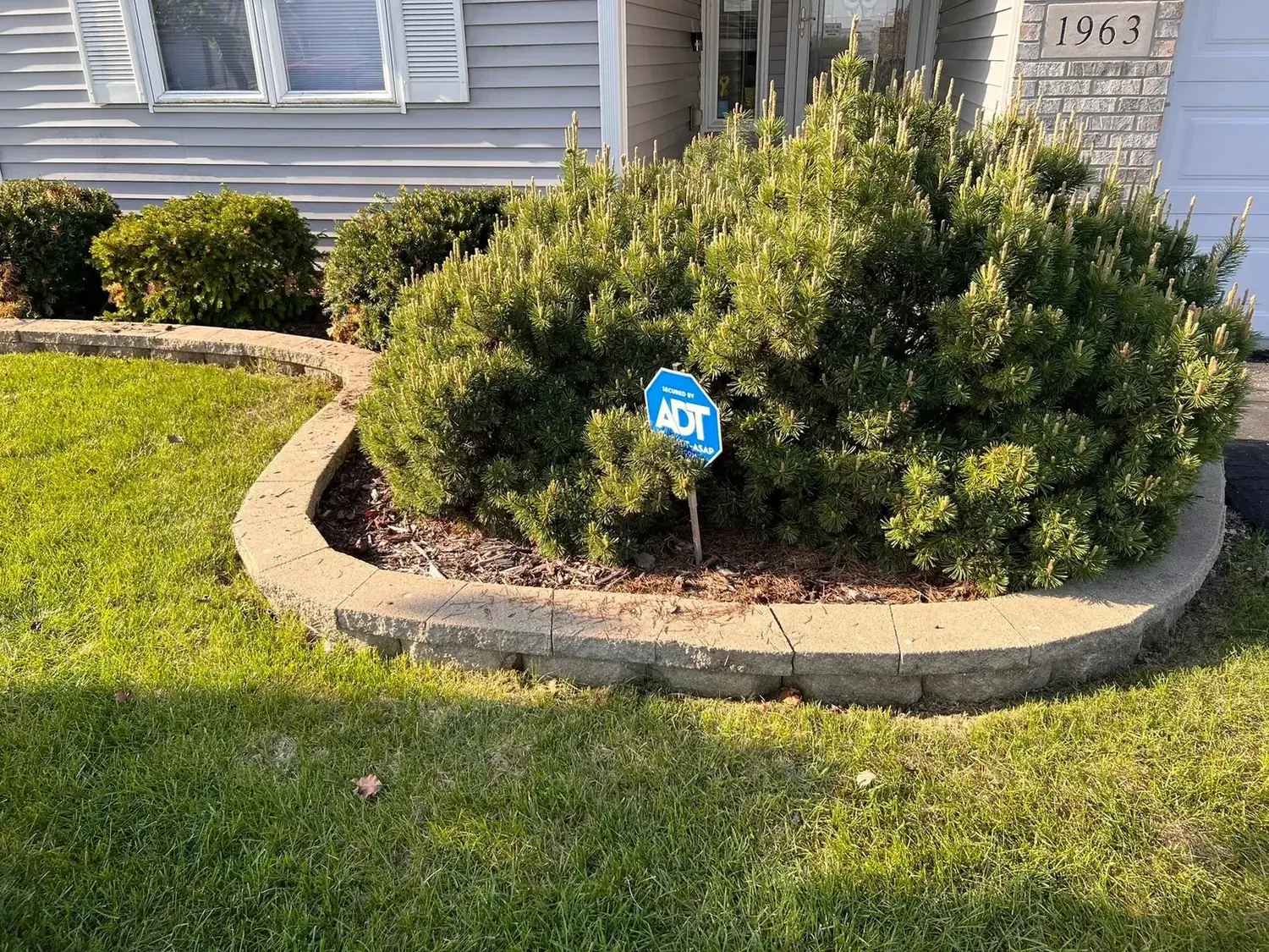 Completed residential landscape bed with stone edging