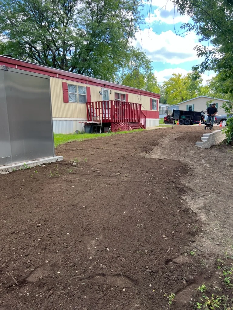 Yard drainage and grading project in progress by Midwest Touch Landscaping LLC